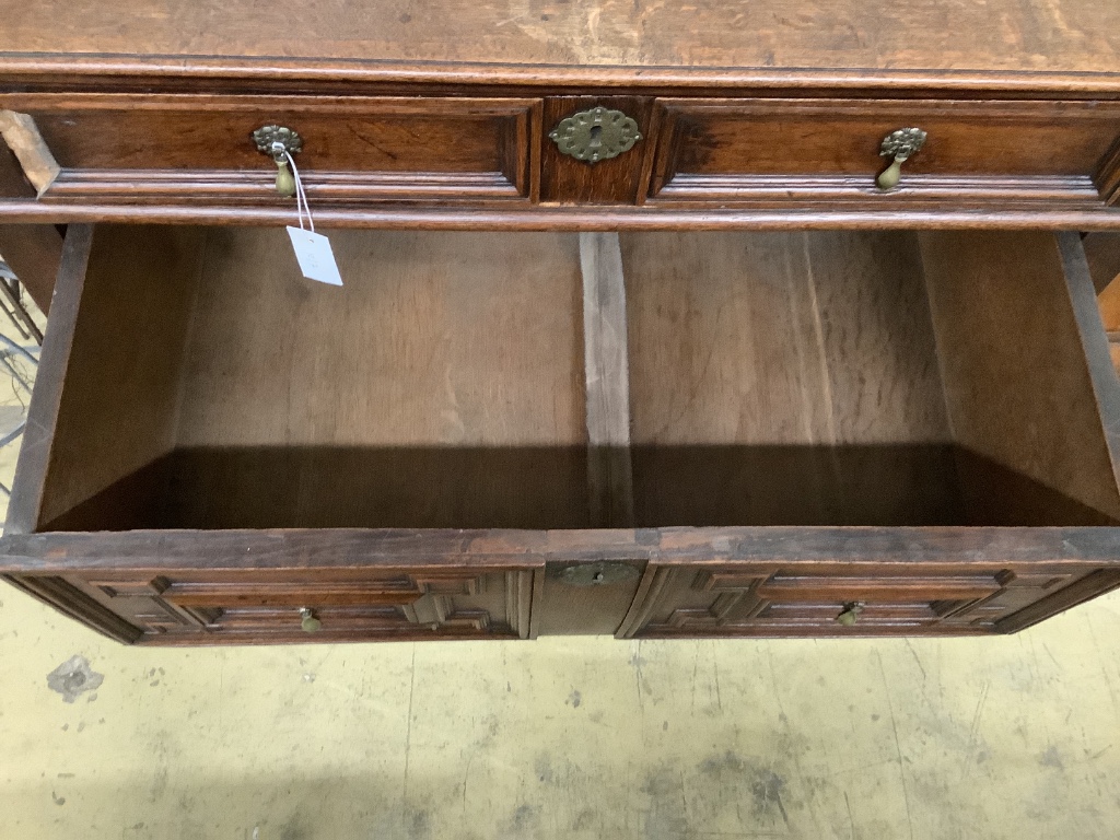 An 18th century oak geometric moulded two part chest, width 105cm, depth 58cm, height 100cm